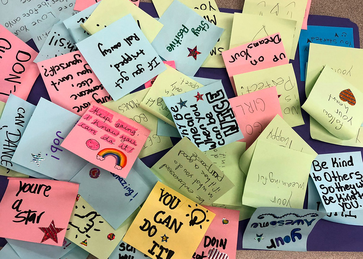 Picture shows hand-written notes with kind messages on them.