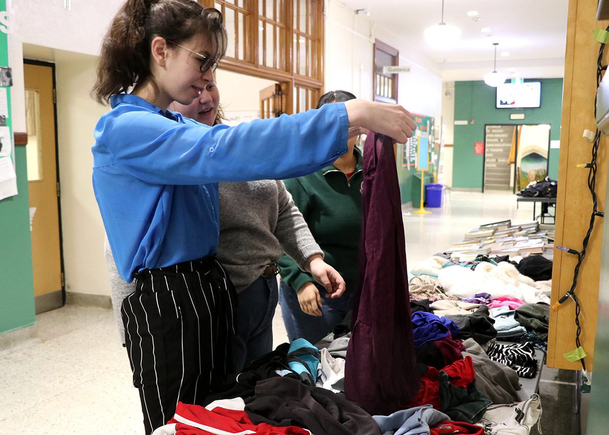 Students look through donated clothes at the GCVI clothing and book swap on Dec. 9, 2019.