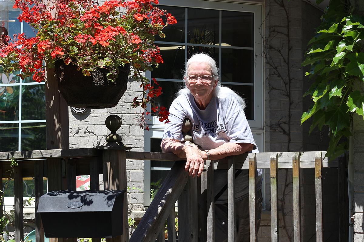 Pat De Vries standing on her porch. 
