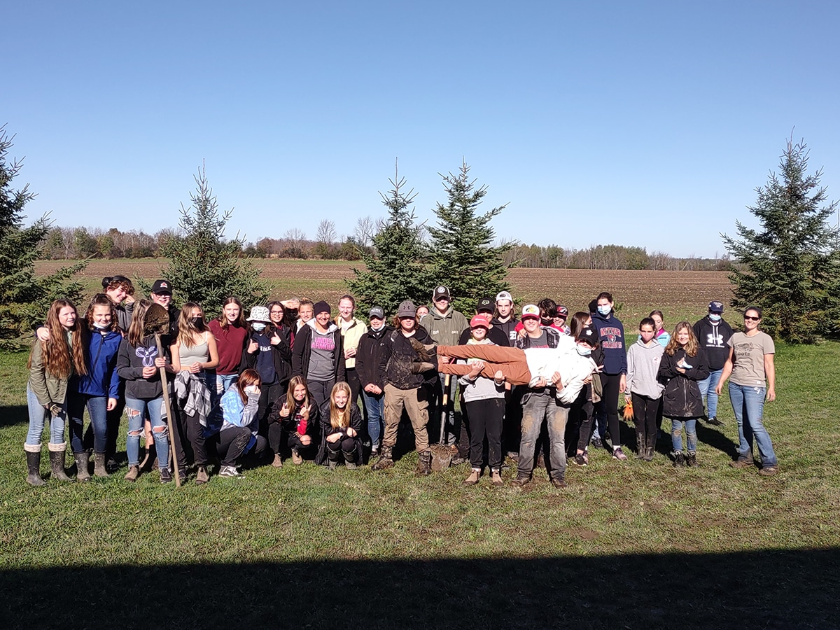 WHSS students posed for a photo after planting tress on the school grounds.