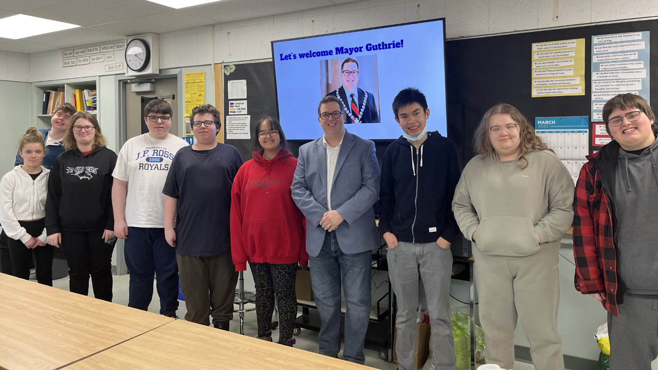 Guelph Mayor Cam Guthrie is pictured with John F. Ross CVI students in March 2023.