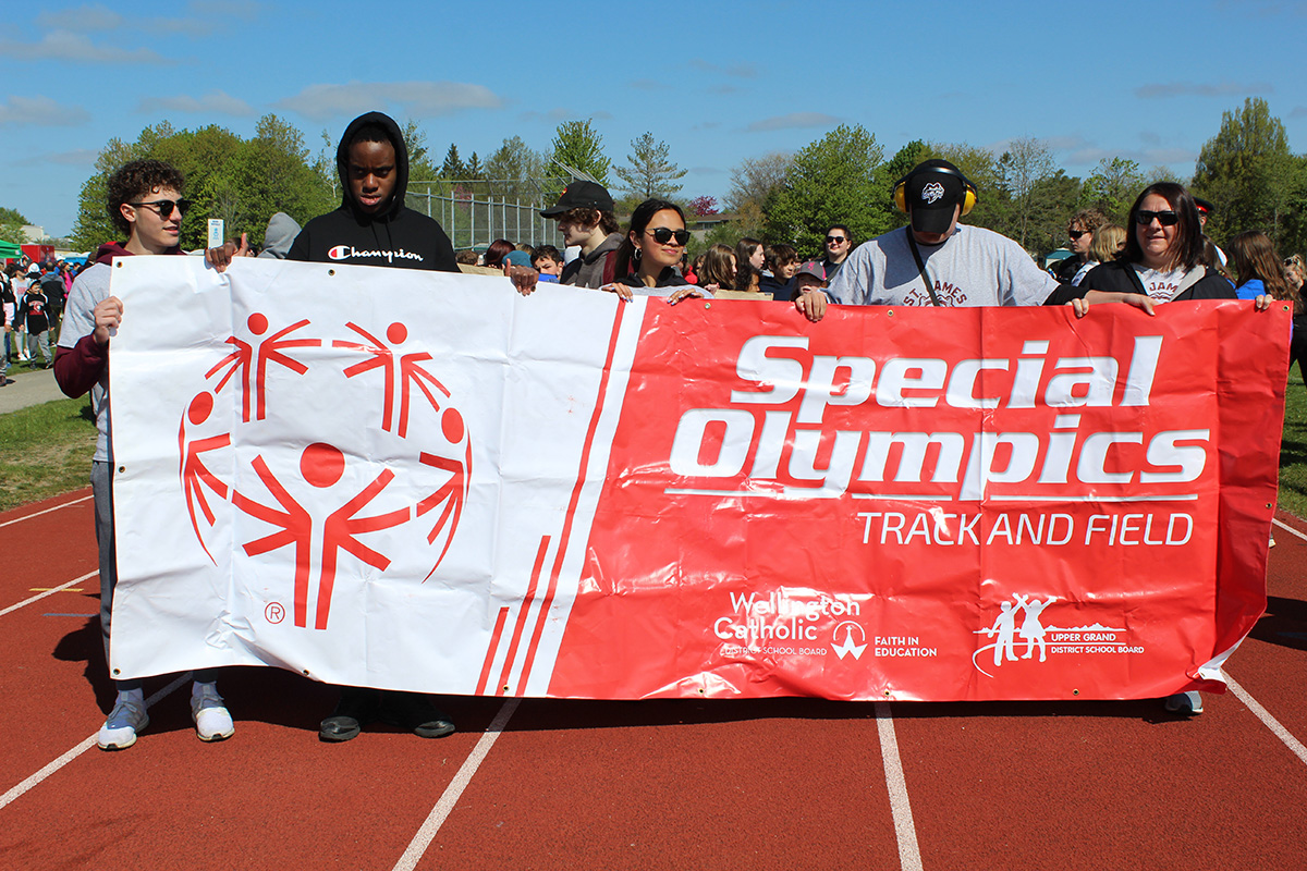 Special Olympics students with banner