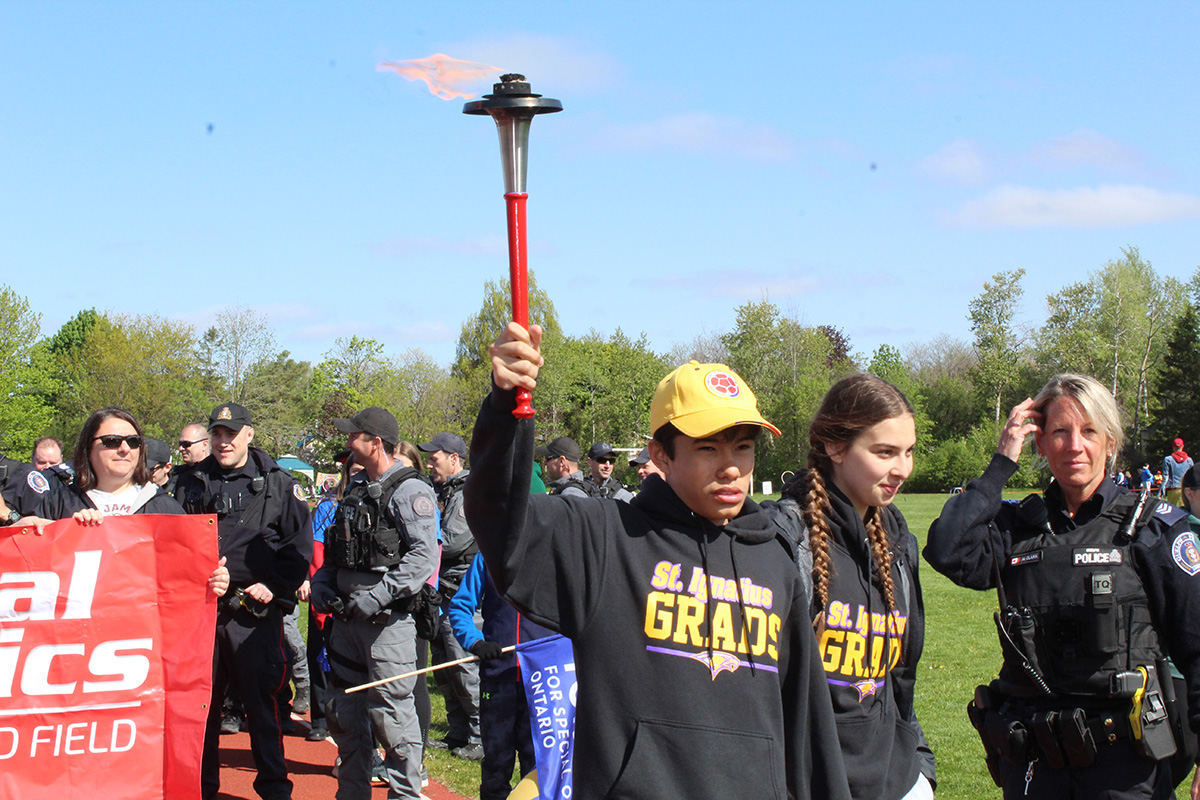Special Olympics student with torch