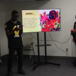 This photo features two students giving a presentation on Afrobeats.