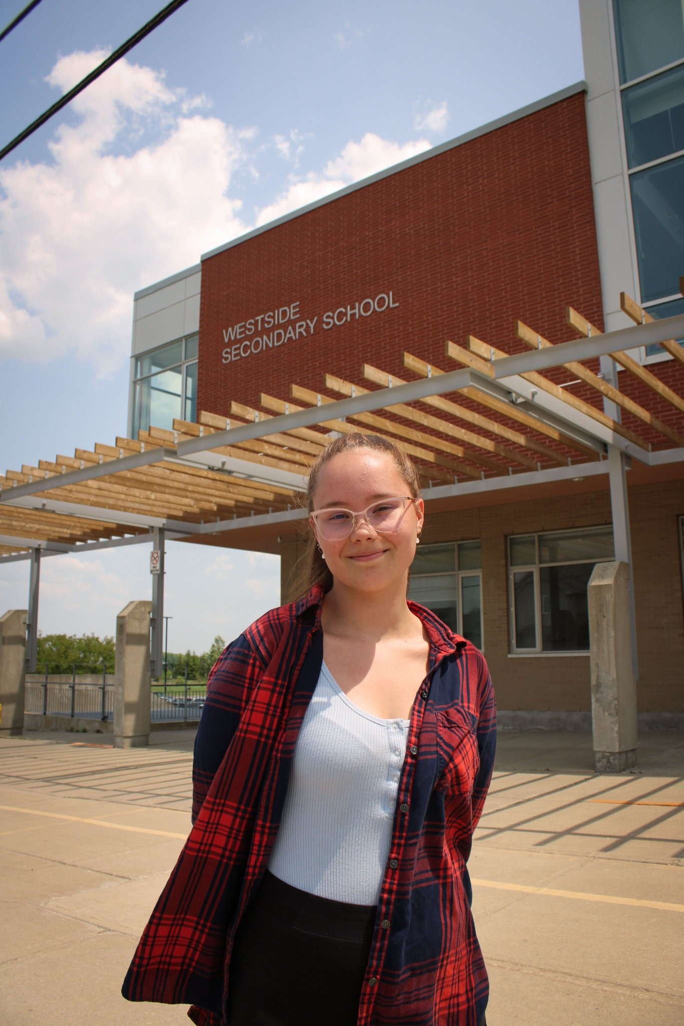 This photo features Madison L standing outside the front of Westside Secondary School.