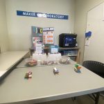 This photo features a lego station with 3 lego structures placed on top of a table.