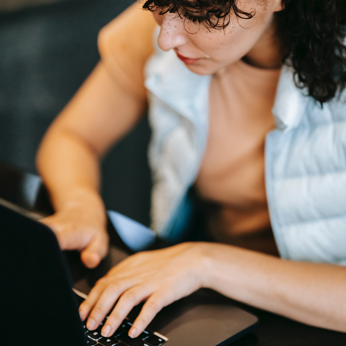 Stock photo of a woman typing on a laptop computer.