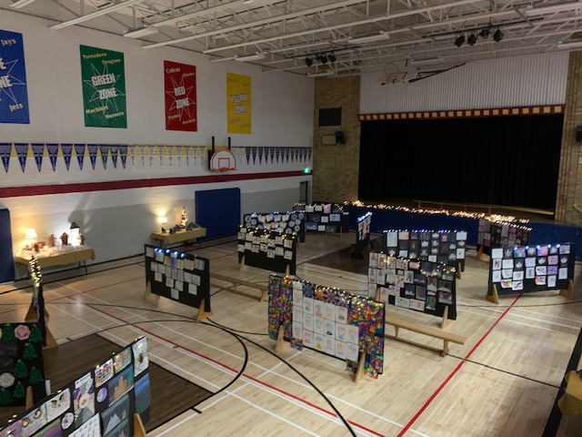 Image shows art displays in a school gym.